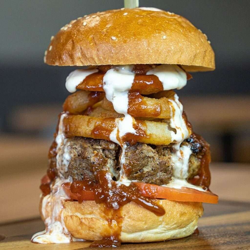 Juicy Lucy burger stacked with waffle fries and gravy