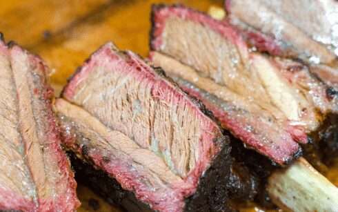 Sliced smoked ribs with a pink smoke ring, cut for serving