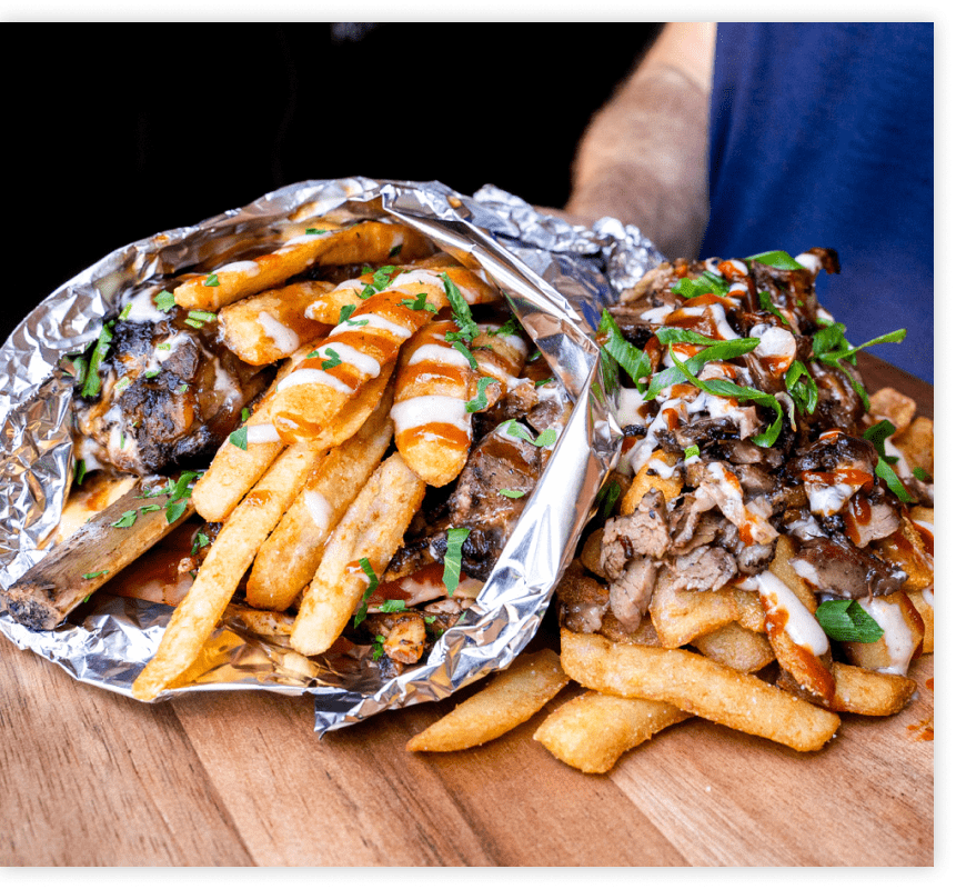 BBQ boat filled with fries, meat and sauce in foil