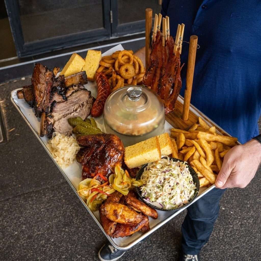 BBQ meat platter with brisket, ribs, corn bread and slaw
