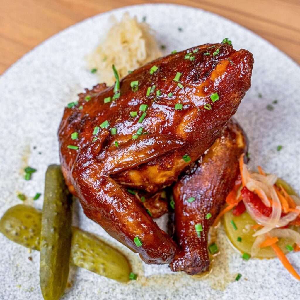 Slow-smoked BBQ chicken glazed, served with pickles and slaw
