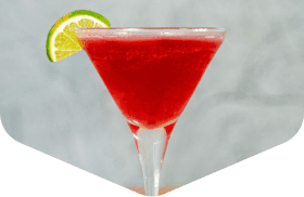 Cocktail in a martini glass with a lime wedge
