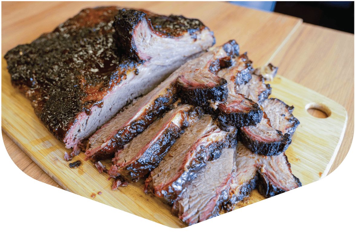 Sliced smoked brisket on a wooden board