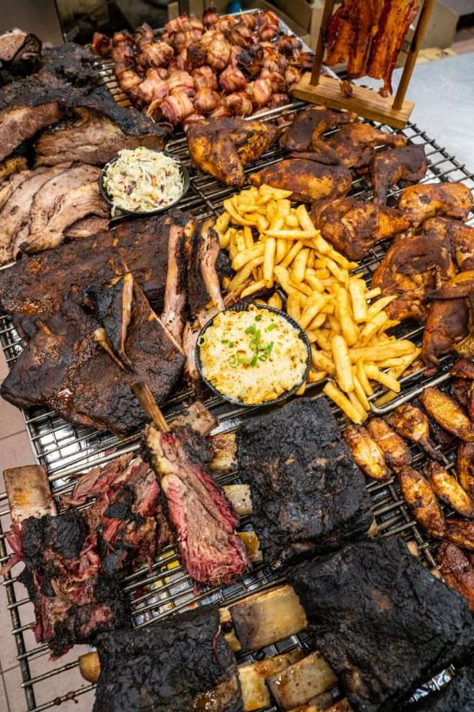 Assorted smoked meats and sides laid out for All You Can Eat BBQ