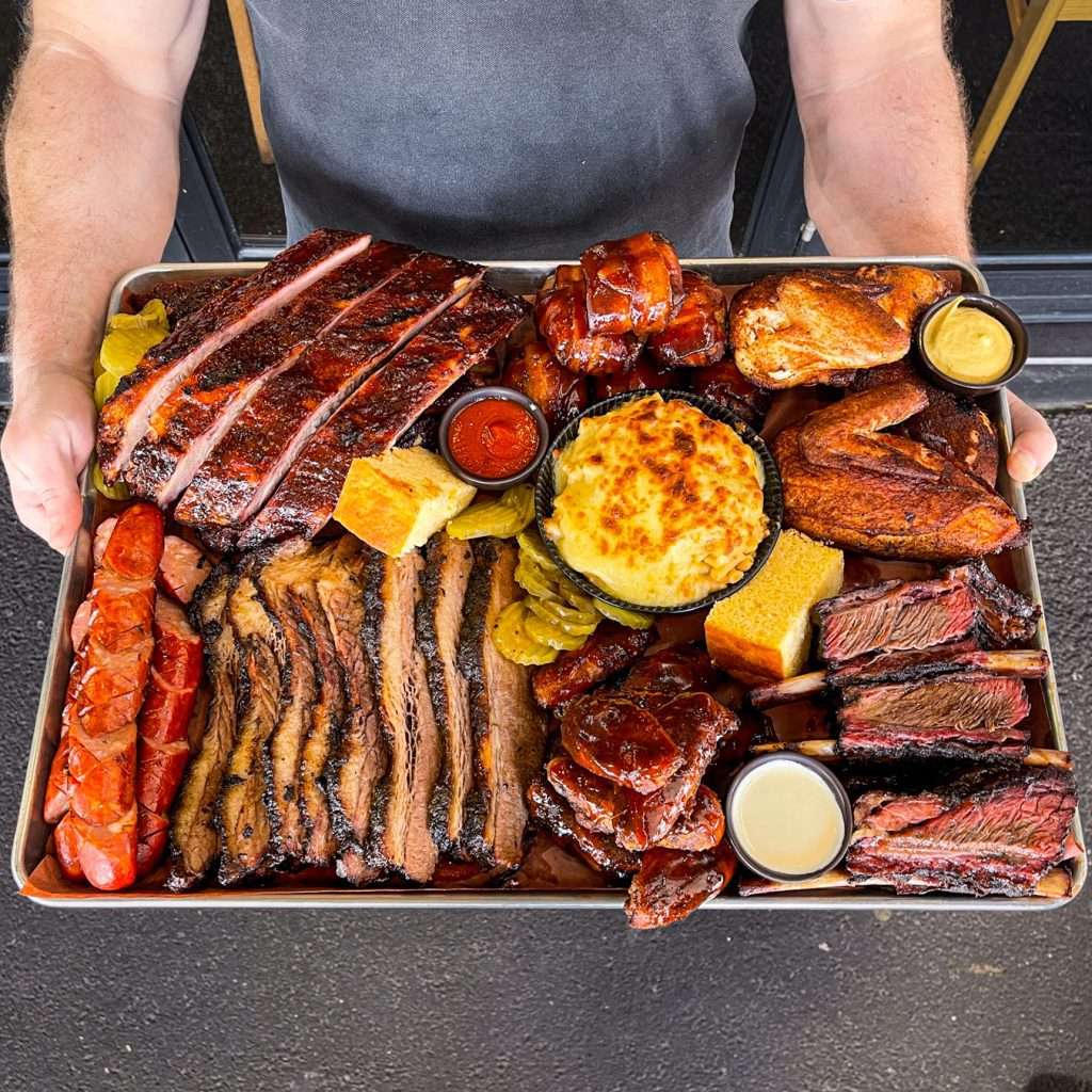 Meat Coma Platter with brisket, ribs, sausage and corn bread