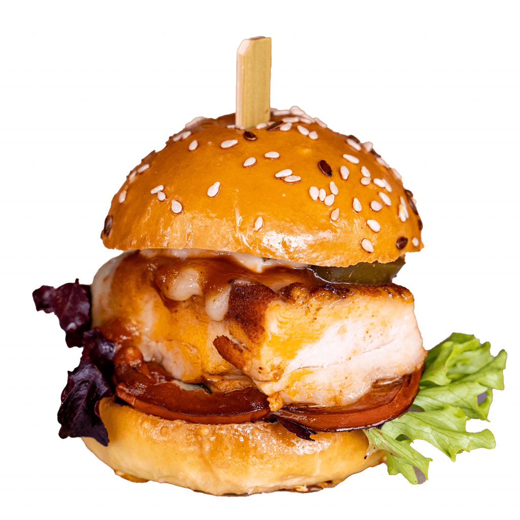 Chicken slider with bacon, cheese sauce and lettuce on a sesame bun