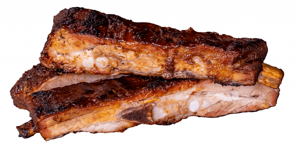 Sliced smoked pork ribs with a charred bark crust
