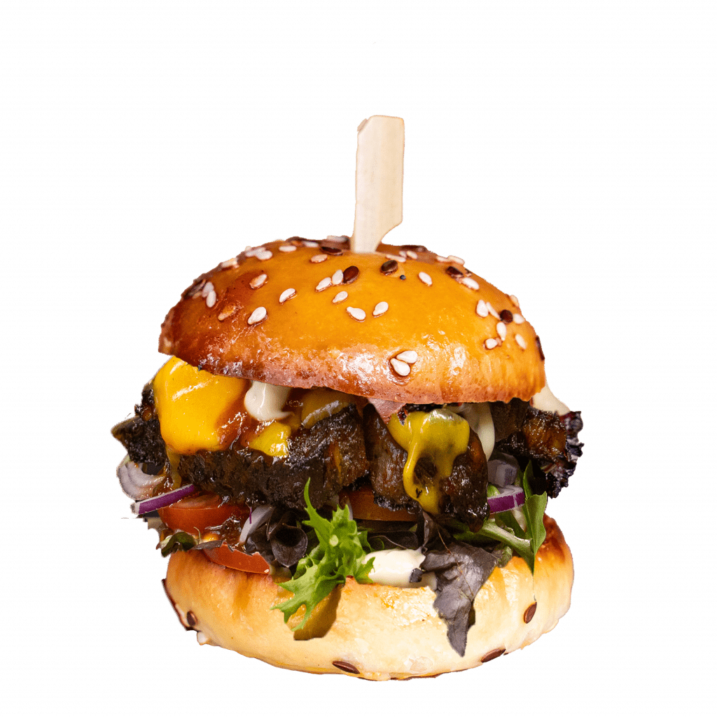 Smoked lamb slider with cheese sauce, tomato and lettuce on a sesame bun