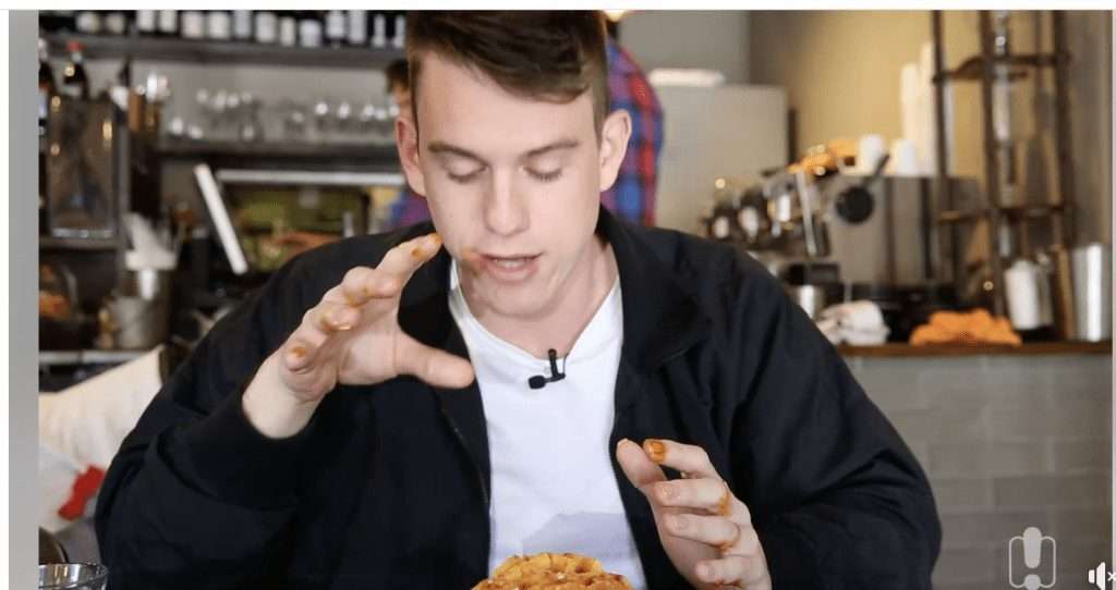 Video review screenshot of a guest eating BBQ food