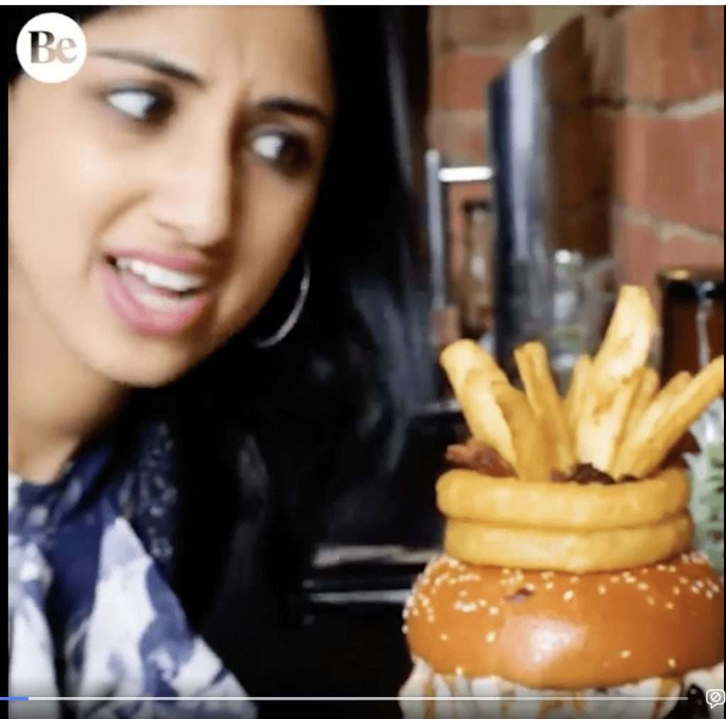 Video screenshot reviewing the boneless buffalo wing waffle burger