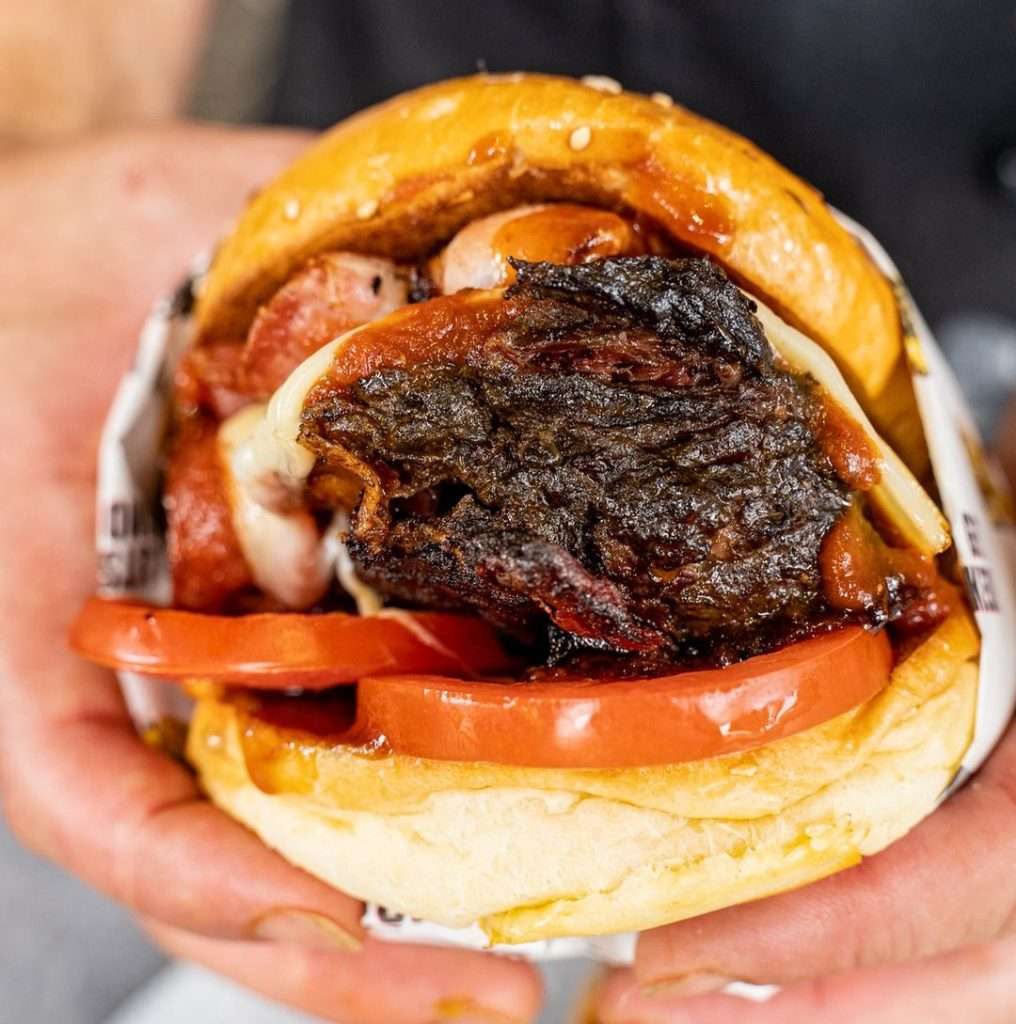 Ribsy burger with smoked meat and melted cheese in a bun