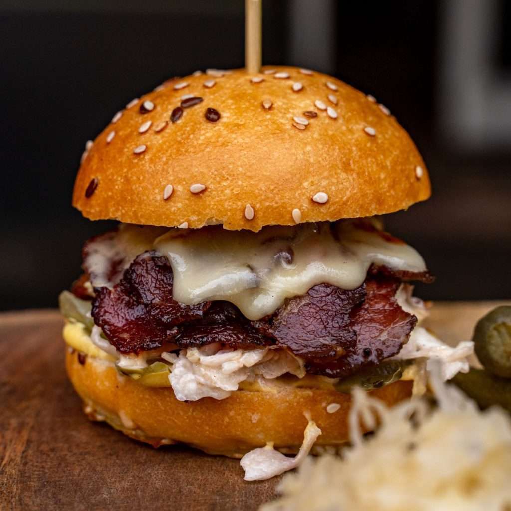 Wagyu Pastrami Slider with melted cheese and coleslaw on a sesame bun