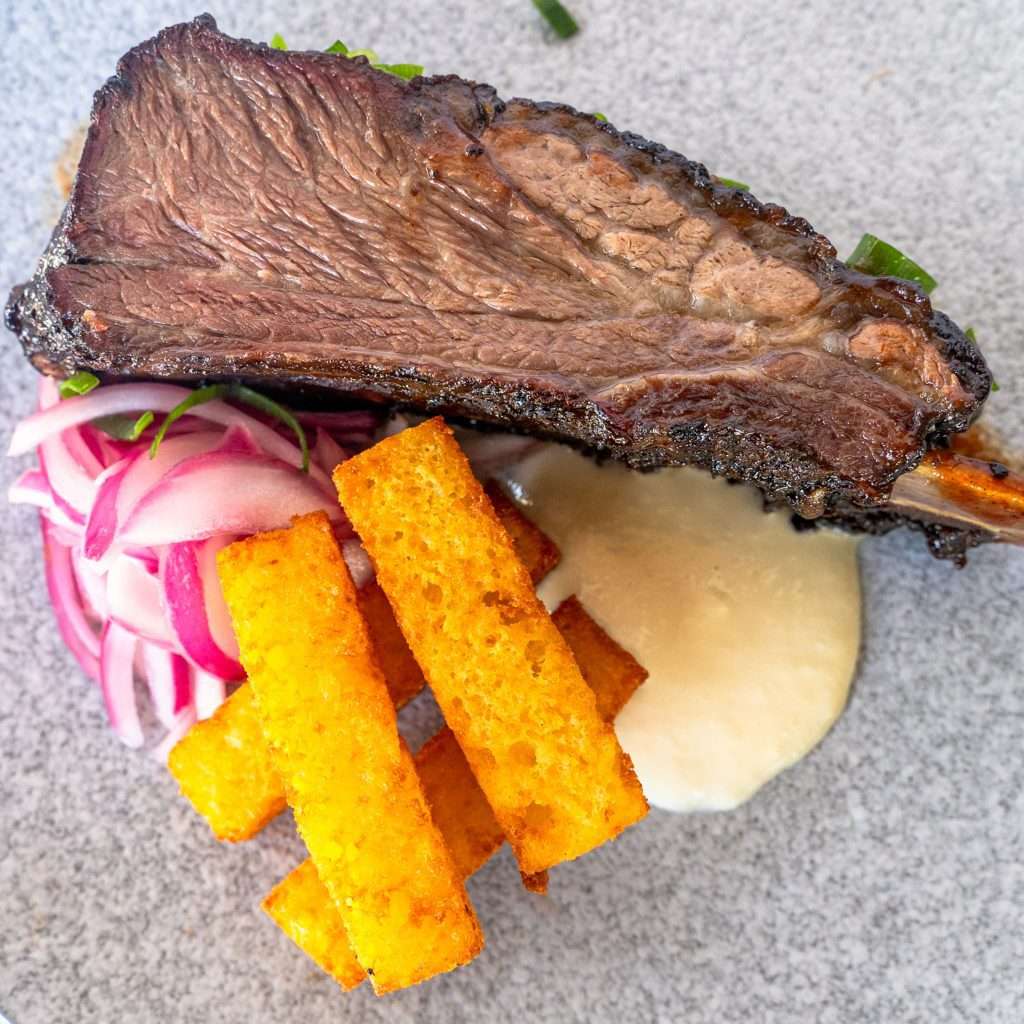 Smoked beef rib with pickled onion, polenta chips and aioli