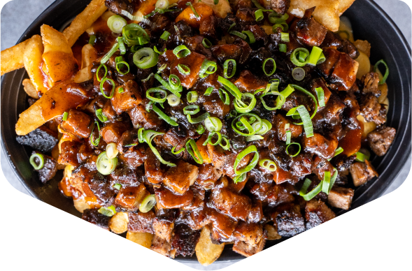 Loaded fries topped with brisket, sauce and spring onion