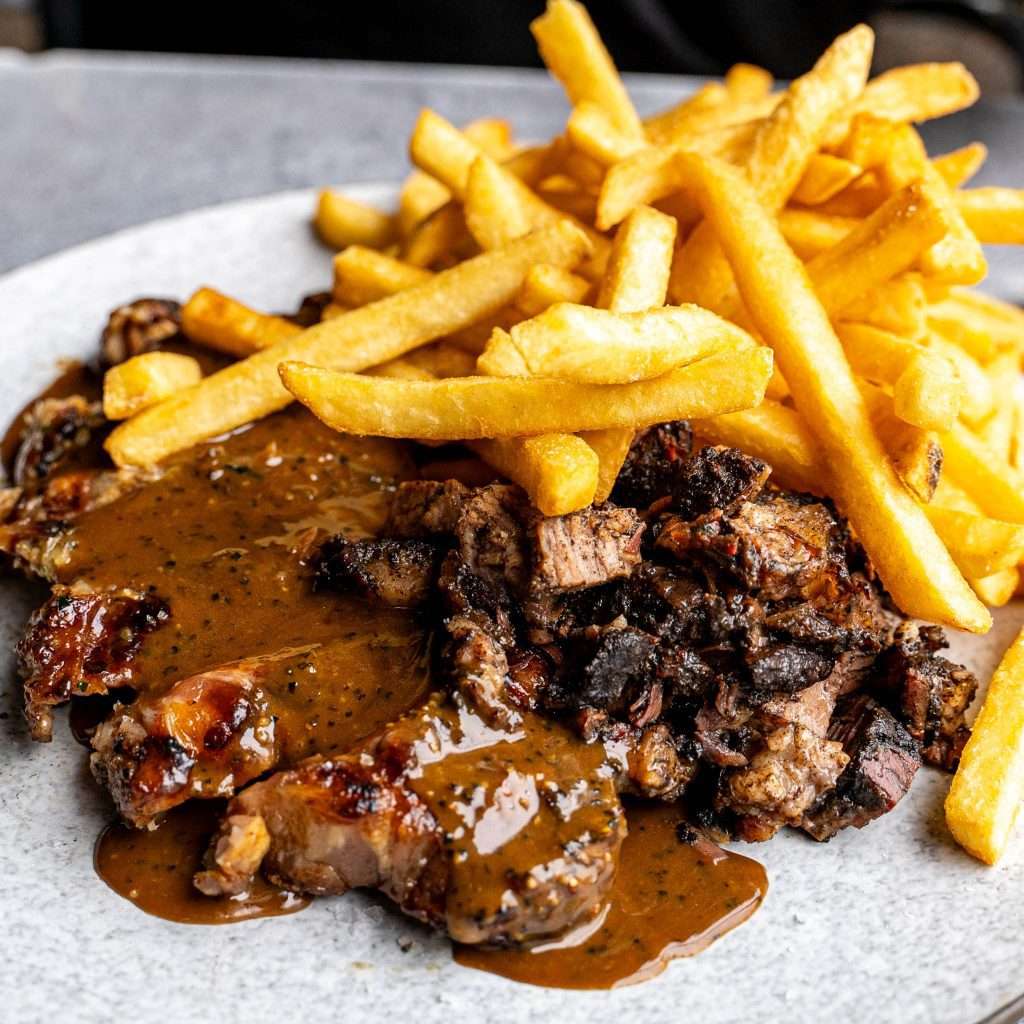 Chopped steak bites with pepper gravy and a side of fries