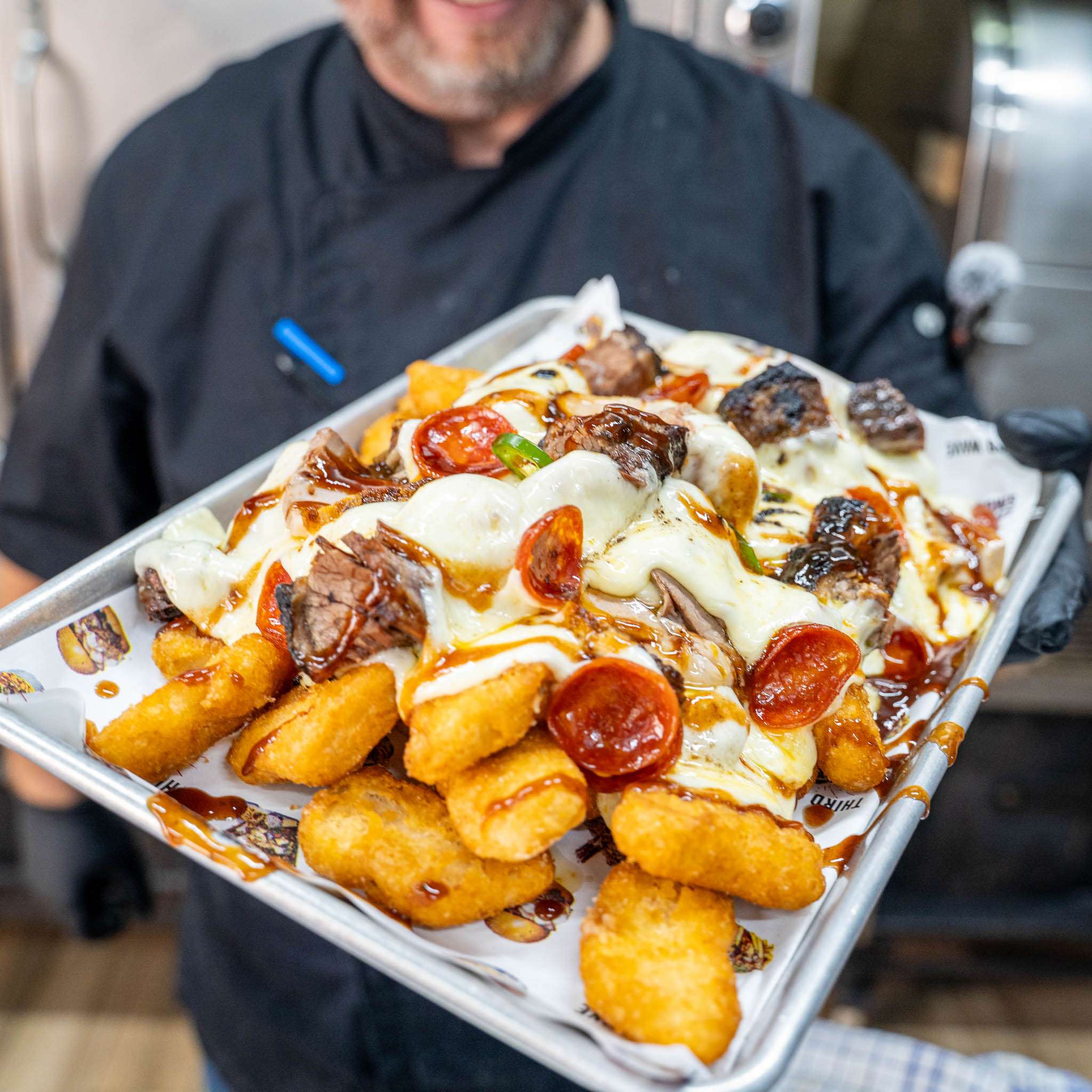 Beast Mode Loaded Nuggets tray topped with cheese sauce and pepperoni