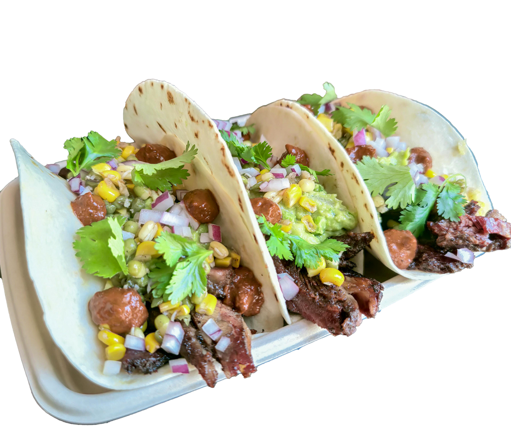 Beef short rib tacos topped with corn, red onion and coriander