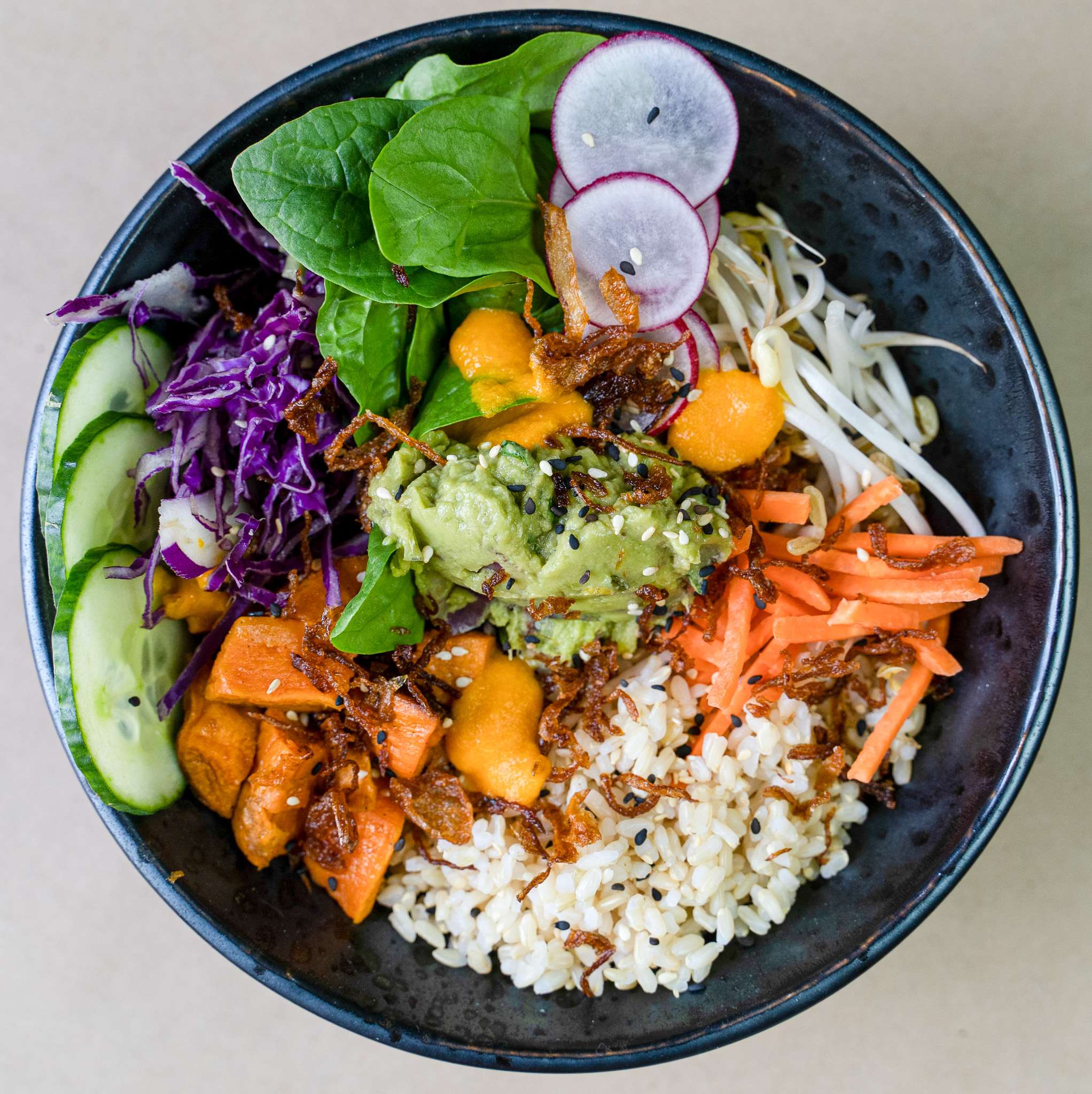 Buddha bowl with rice, spinach, cucumber and mango