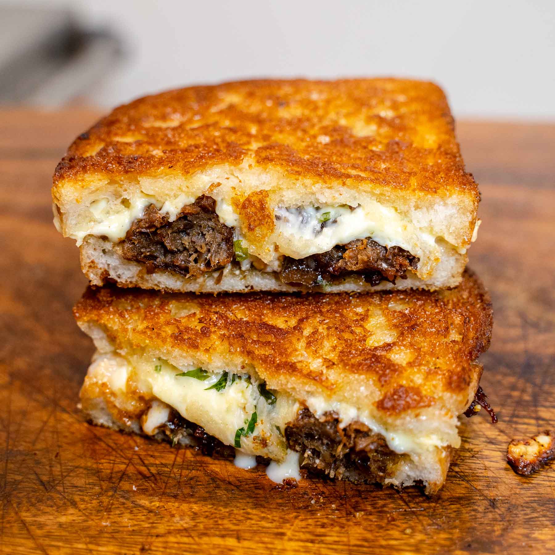 The Fabletarian vegetarian toastie halves on a wooden board