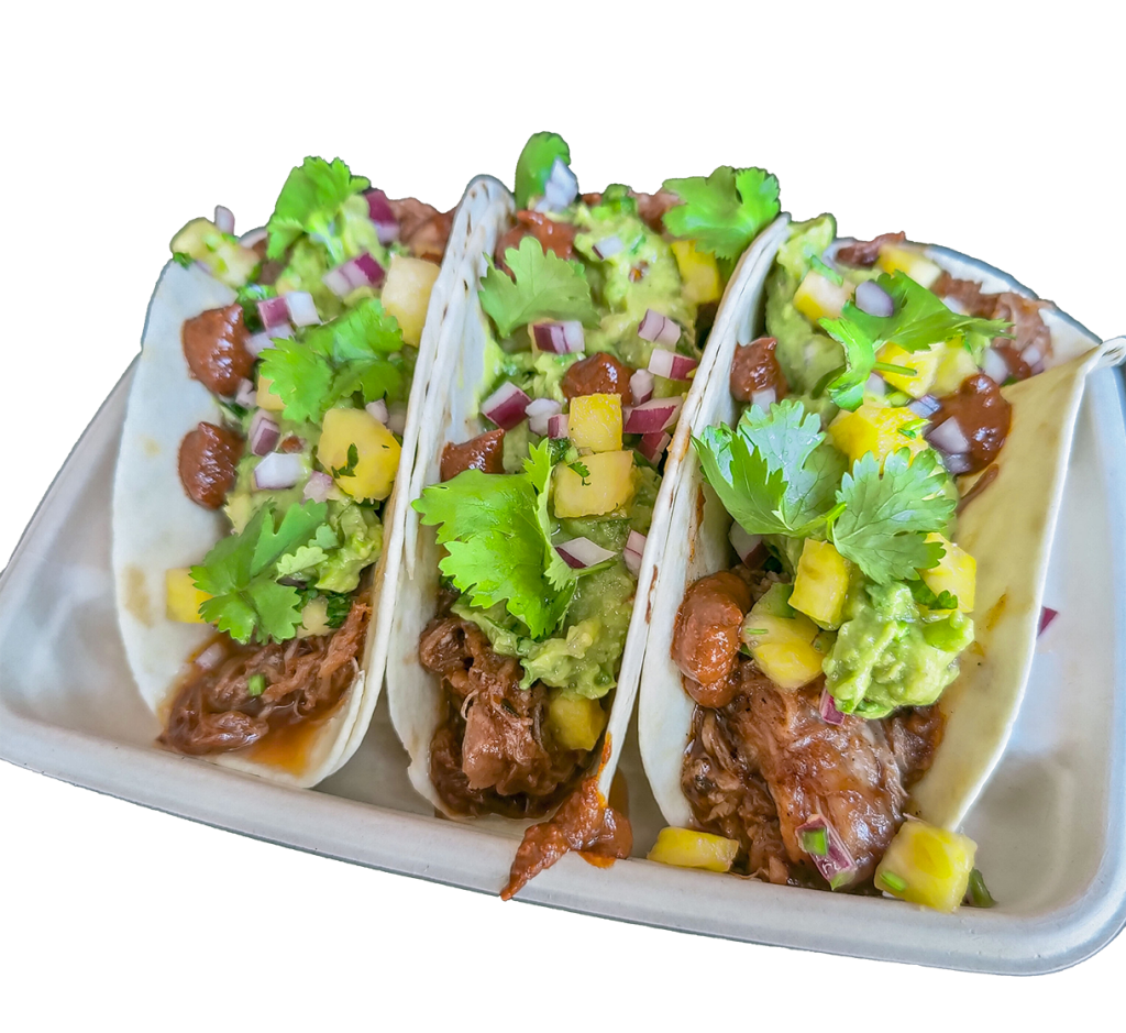 Pulled pork tacos topped with mango and guacamole