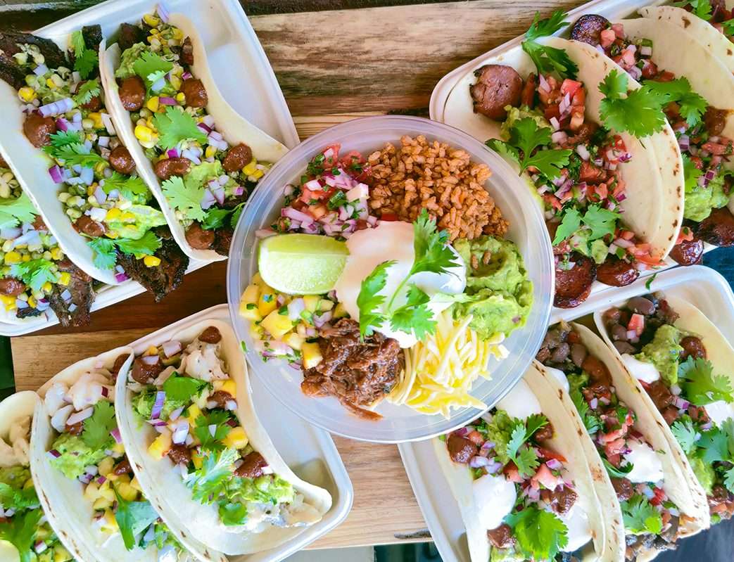 Overhead view of tacos and a burrito bowl for catering