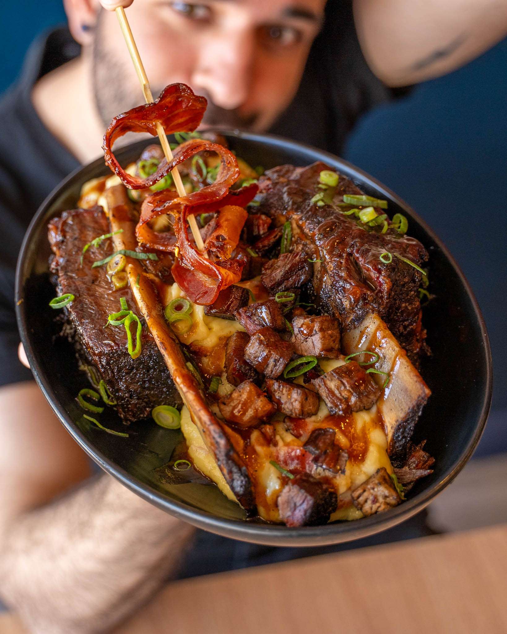 BBQ Banana Split dish: a rib bone with glazed meat chunks and chilli garnish