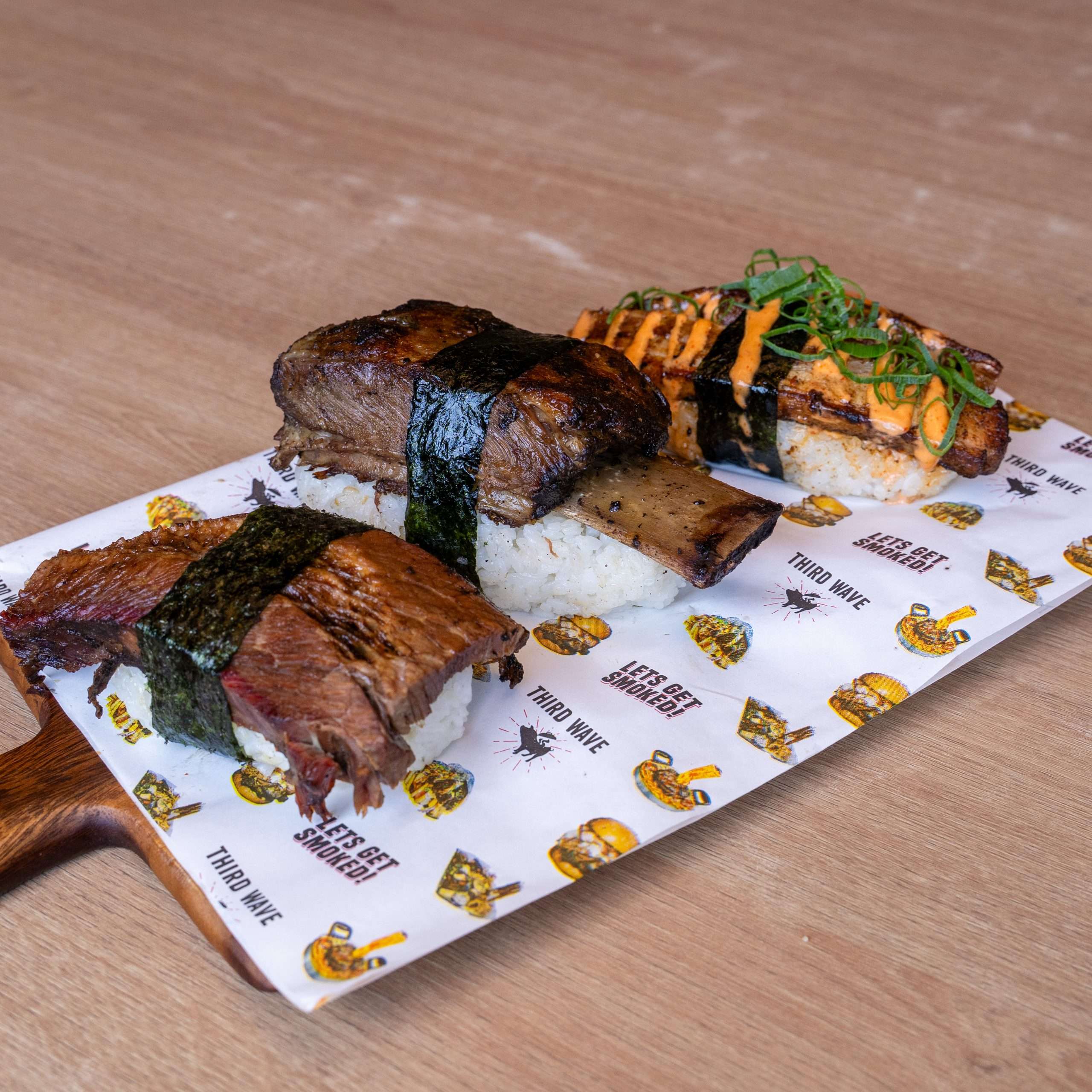 Two pieces of BBQ Nigiri with meat wrapped in nori over rice