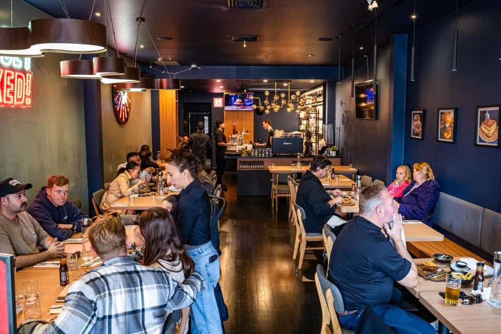 Dining room interior with guests seated at Third Wave BBQ Albert Park