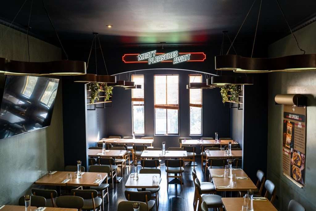 Dining room interior with large windows at Third Wave BBQ Albert Park