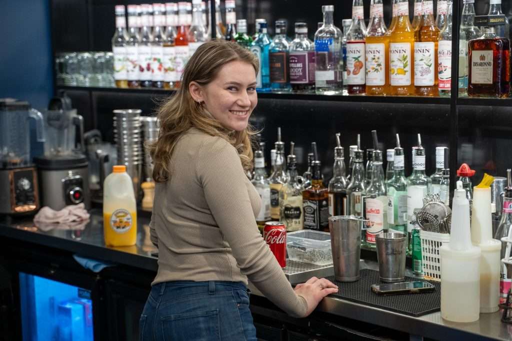 Staff member behind the bar at Third Wave BBQ Albert Park