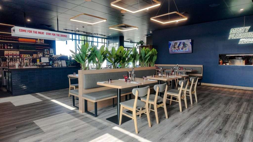 Booth seating with pendant lighting at Third Wave BBQ Officer