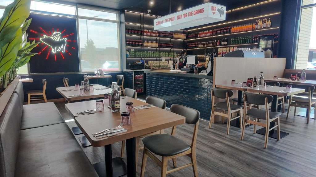 Dining tables and bar area at Third Wave BBQ Officer