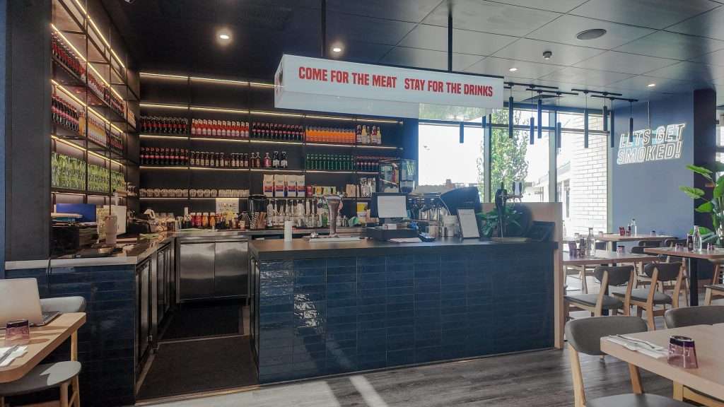 Bar counter with pass-through window at Third Wave BBQ Officer