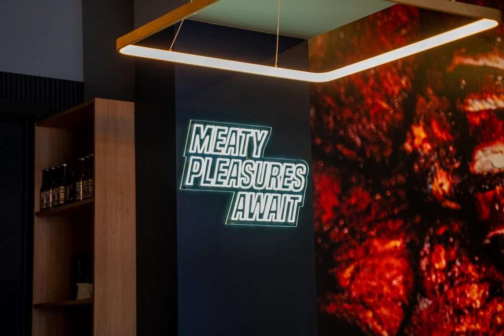 'Meaty pleasures await' neon sign at Third Wave BBQ Hawthorn East