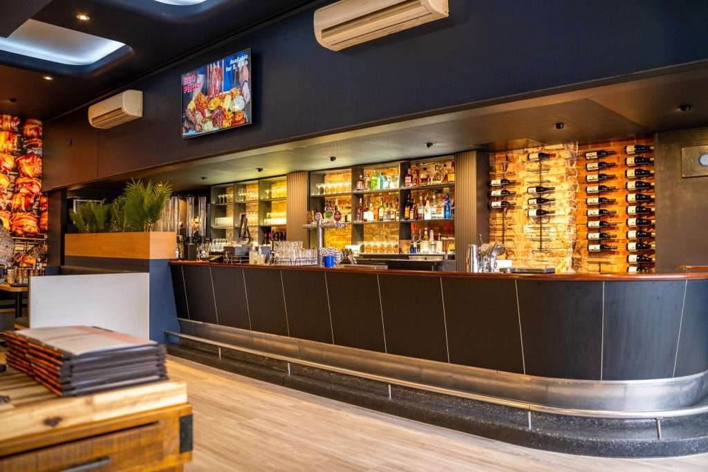 Bar area with shelved spirits at Third Wave BBQ Hawthorn East