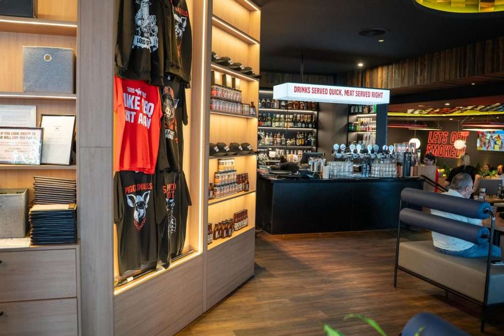 Merchandise shelf and bar area at Third Wave BBQ Applecross