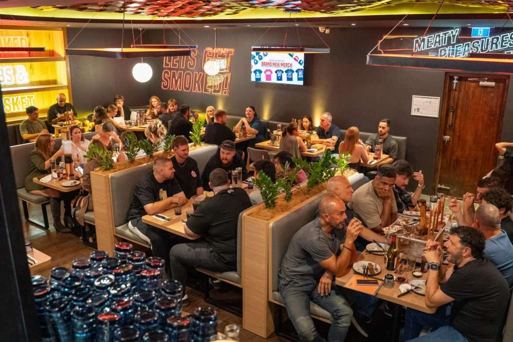Guests dining in a booth at Third Wave BBQ Applecross