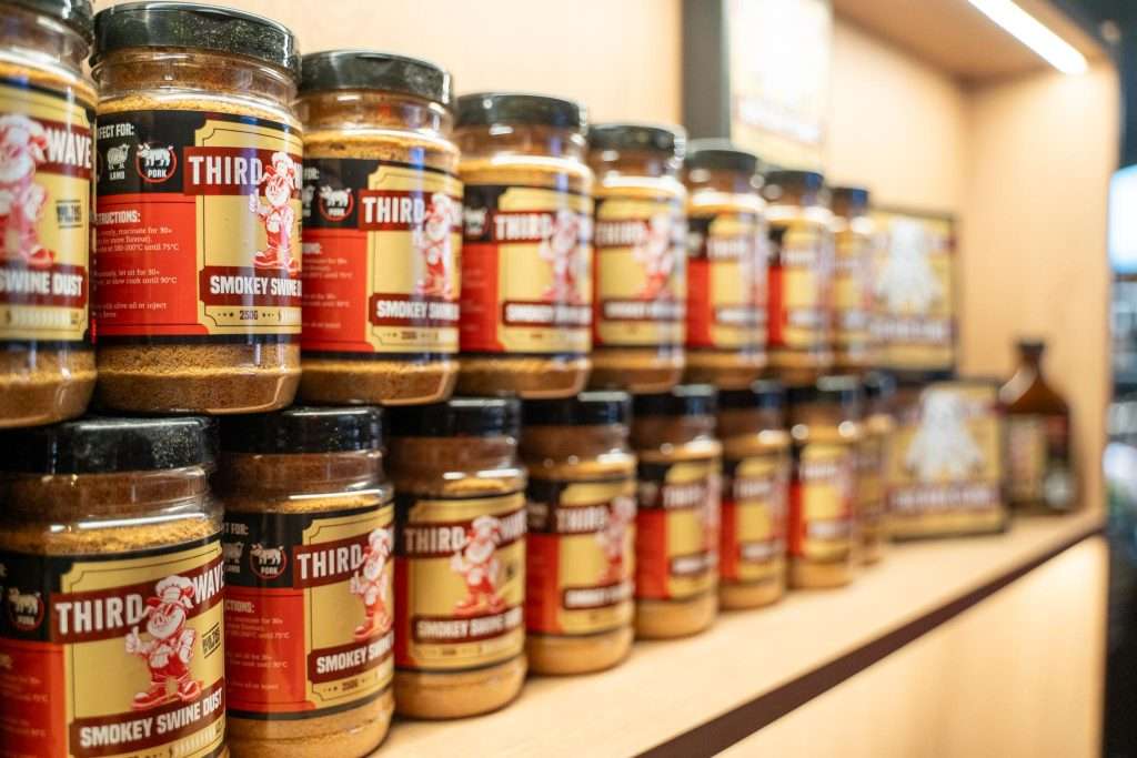 Jars of Third Wave BBQ spice rub on a display shelf