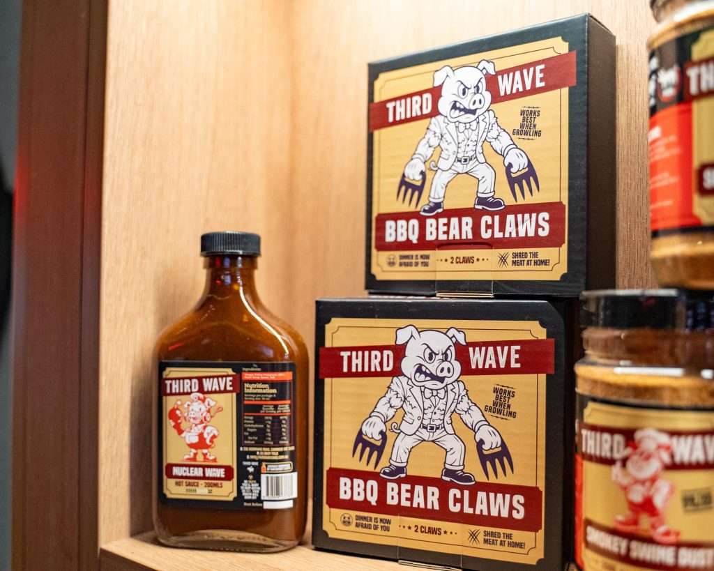 Third Wave BBQ Bear Claws and hot sauce bottles on a shelf