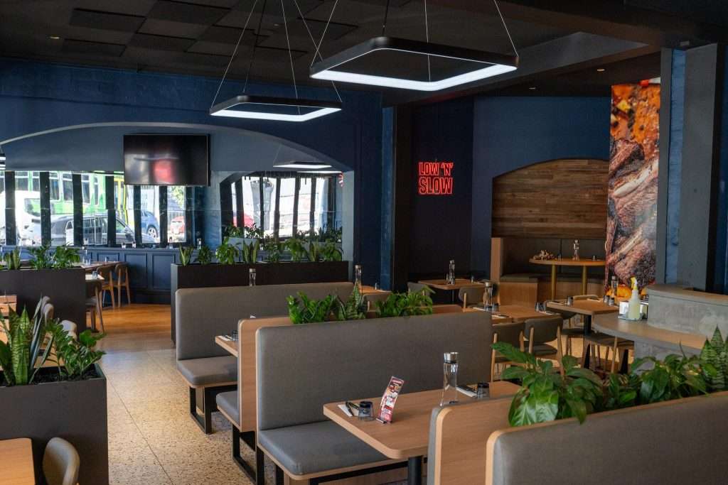 Empty dining room with wood tables at Third Wave BBQ Ascot Vale