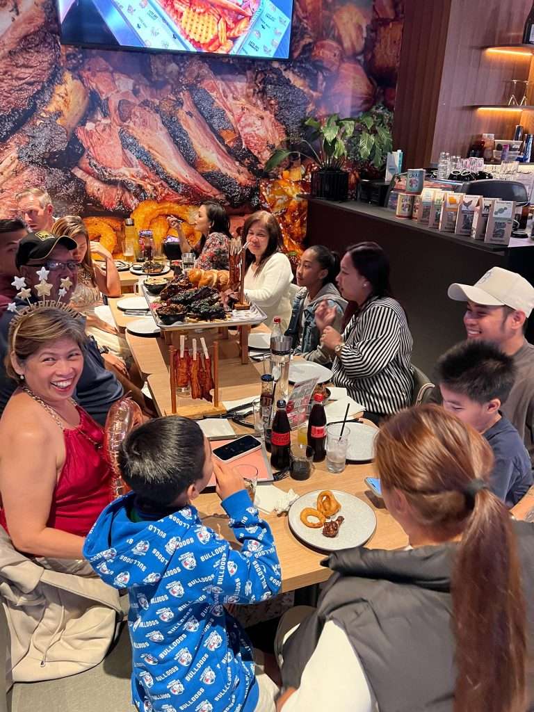 Family seated at a table at Third Wave BBQ Ascot Vale
