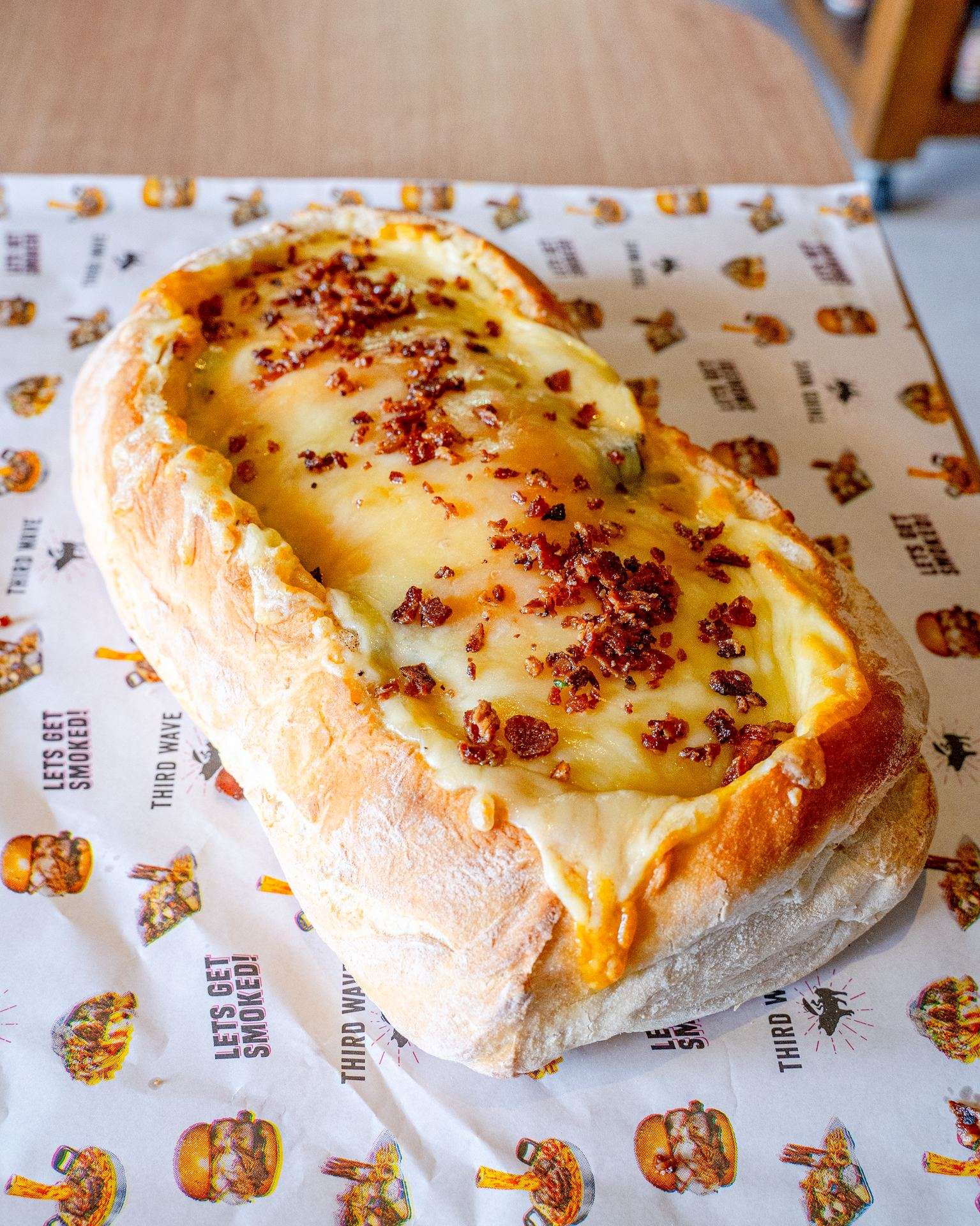 BBQ boat bread roll filled with melted cheese and bacon