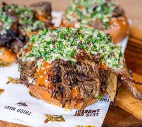 Garlic Beef BBQ Bombs topped with herbs on a board