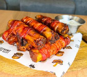 BBQ shotgun shells stacked with a side of dipping sauce