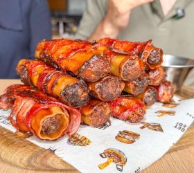 Bacon-wrapped BBQ shotgun shells on a board