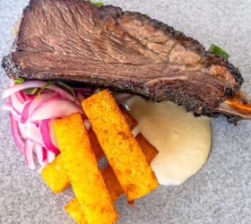 Smoked beef rib with pickled onion, polenta chips and aioli