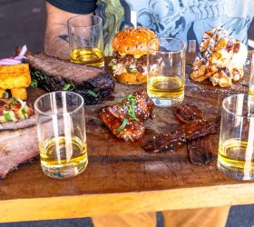 BBQ and Bourbon Degustation board with ribs, wings and bourbon glasses