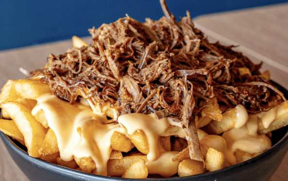 Birria fries topped with shredded beef and cheese sauce