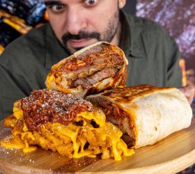 Brisket Lasagna Burrito halves with melted cheese pull on a board