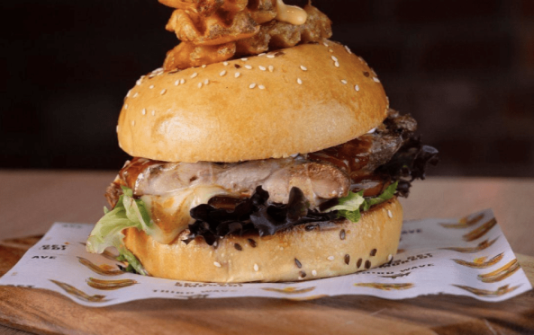 Chicken burger with crispy chicken and a waffle fry skewer